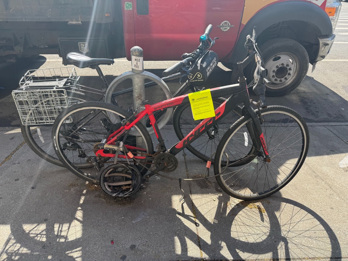 A bike with a yellow DSNY derelict bicycle sticker in Brooklyn