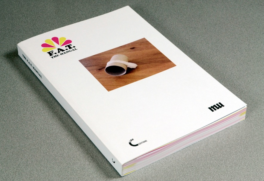 The F.A.T. Manual, a thick white paperback with the peacock logo and a photo on the cover